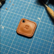 Load image into Gallery viewer, Leather hand-stitched NFC key fob with a brand logo on a blue grid surface